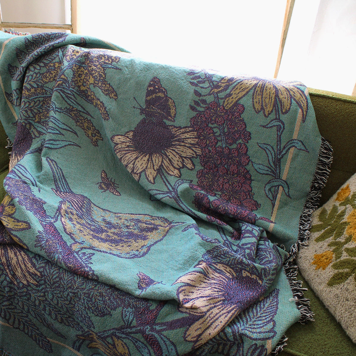 Mustard Beetle Prairie Woven Blanket Tapestry on a couch at home.