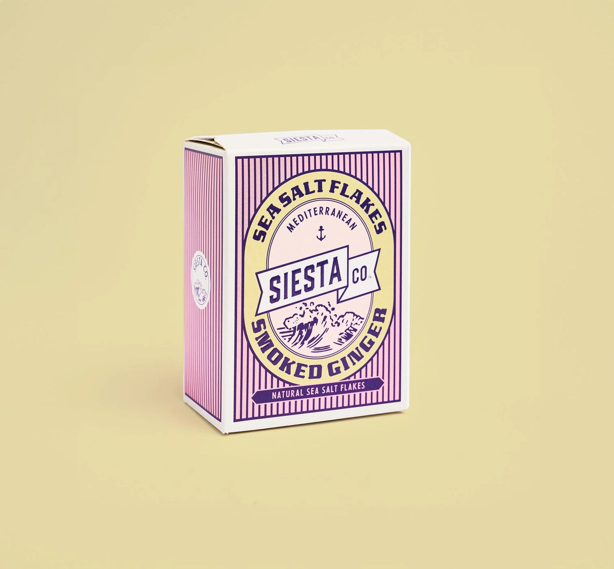 Pink and purple packaging of Siesta Co. Ginger Sea Salt Flakes on a beige background