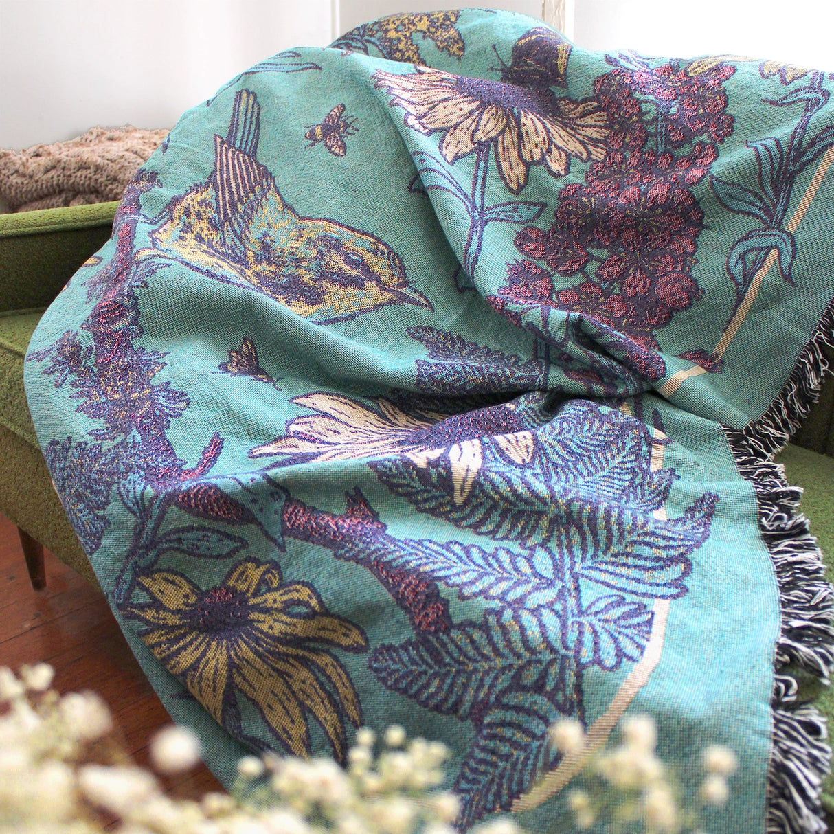 Mustard Beetle Prairie Woven Blanket Tapestry on a couch at home.