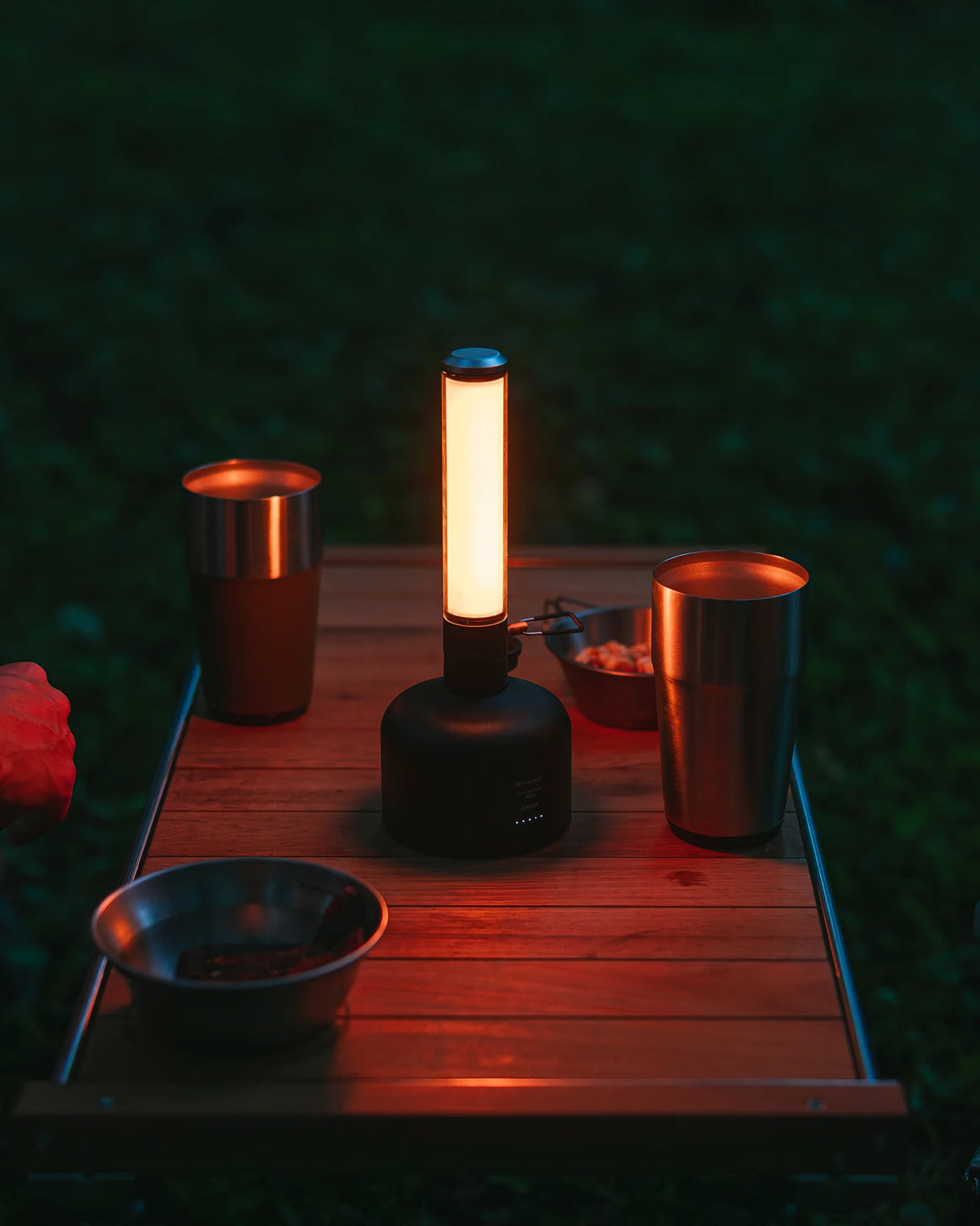 Snow Peak GigaPower Tabletop Lantern being used while camping and showing the warm light mode.