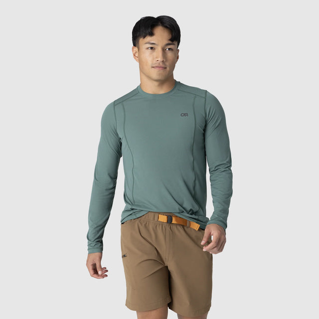 Man wearing an Outdoor Research Men's Echo Long Sleeve Tee in Malachite on a white background