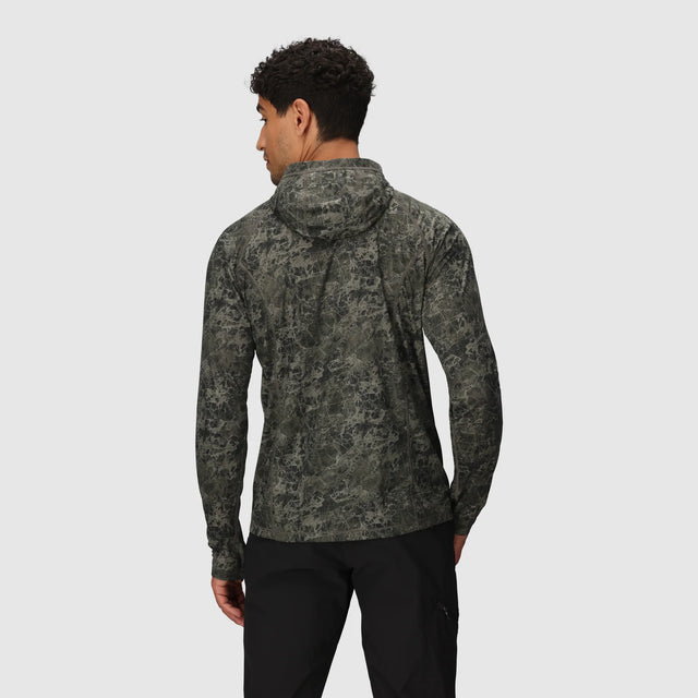 Person wearing a Outdoor Research Men's Echo Hoodie in Ranger Green Granite Print on a light gray background