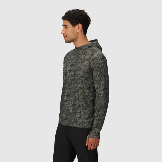 Man wearing a Outdoor Research Men's Echo Hoodie in Ranger Green Granite Print on a white background