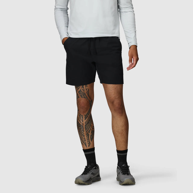 Person wearing Outdoor Research Men's Swift Lite Hybrid Shorts 7" in Black on a plain background