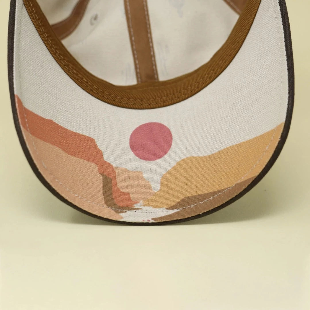 Underside of the 6-panel hat made from sustainable materials depicts a desert sunset.