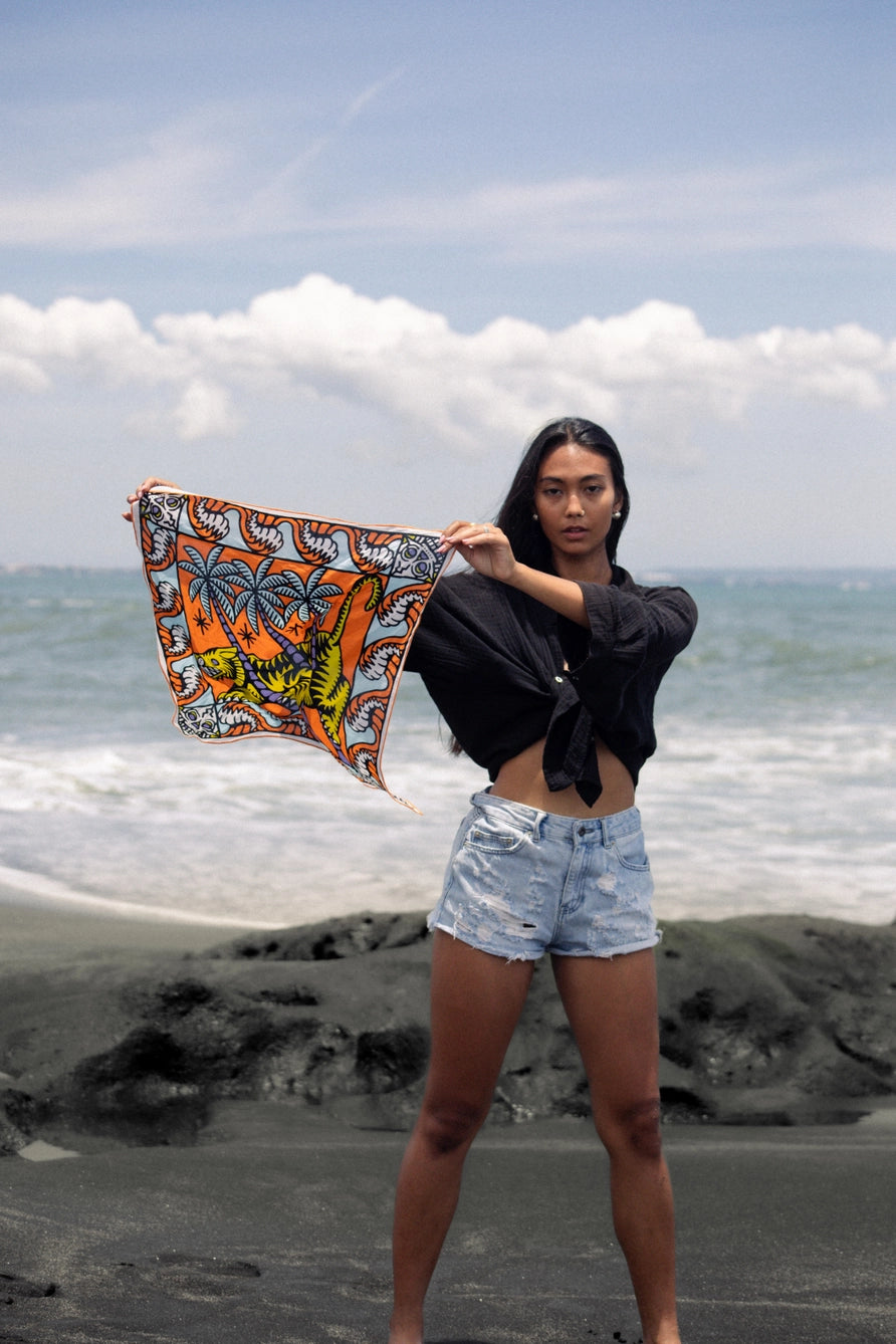Bandits Bandana Trapped In bandana being held by a woman on the beach.