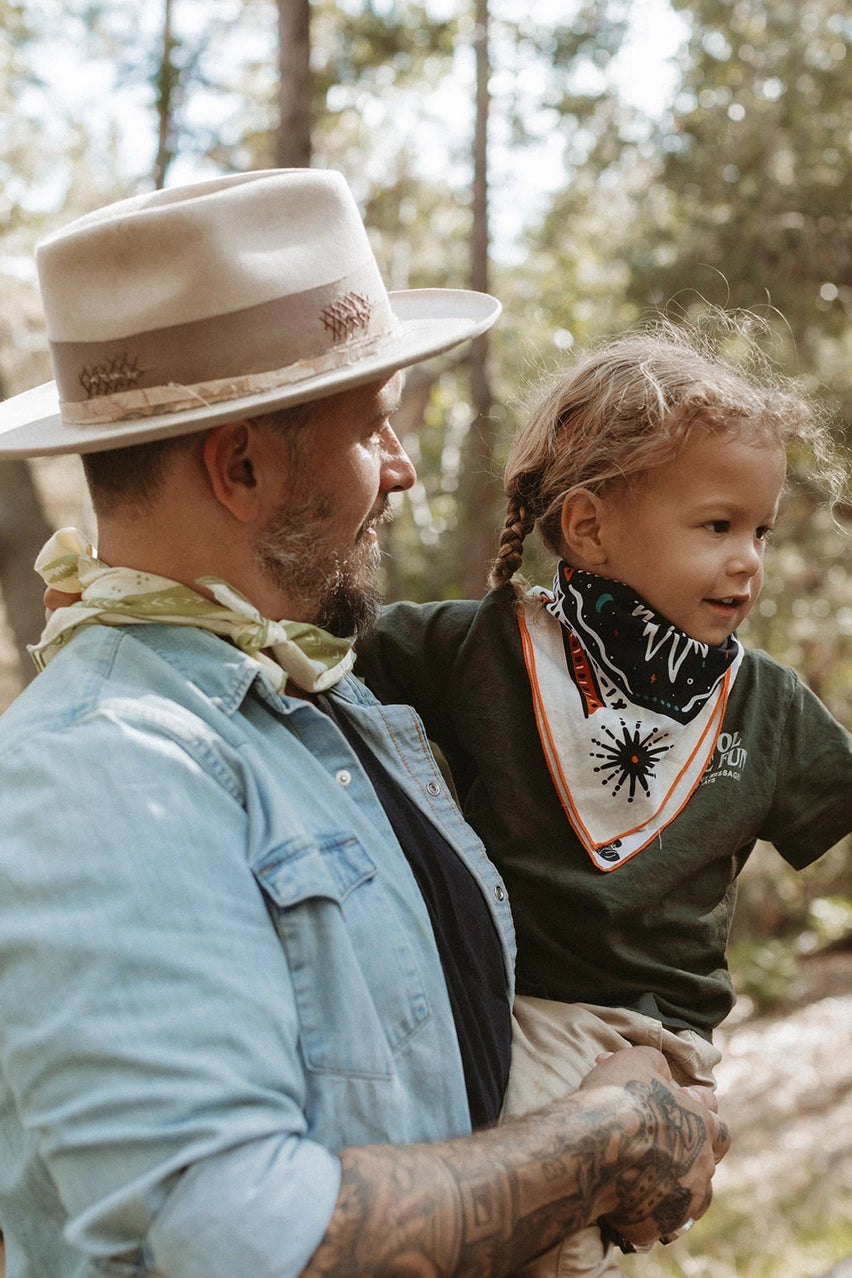 Bandits Bandana Get Lost bandana being worn by a child outdoors.