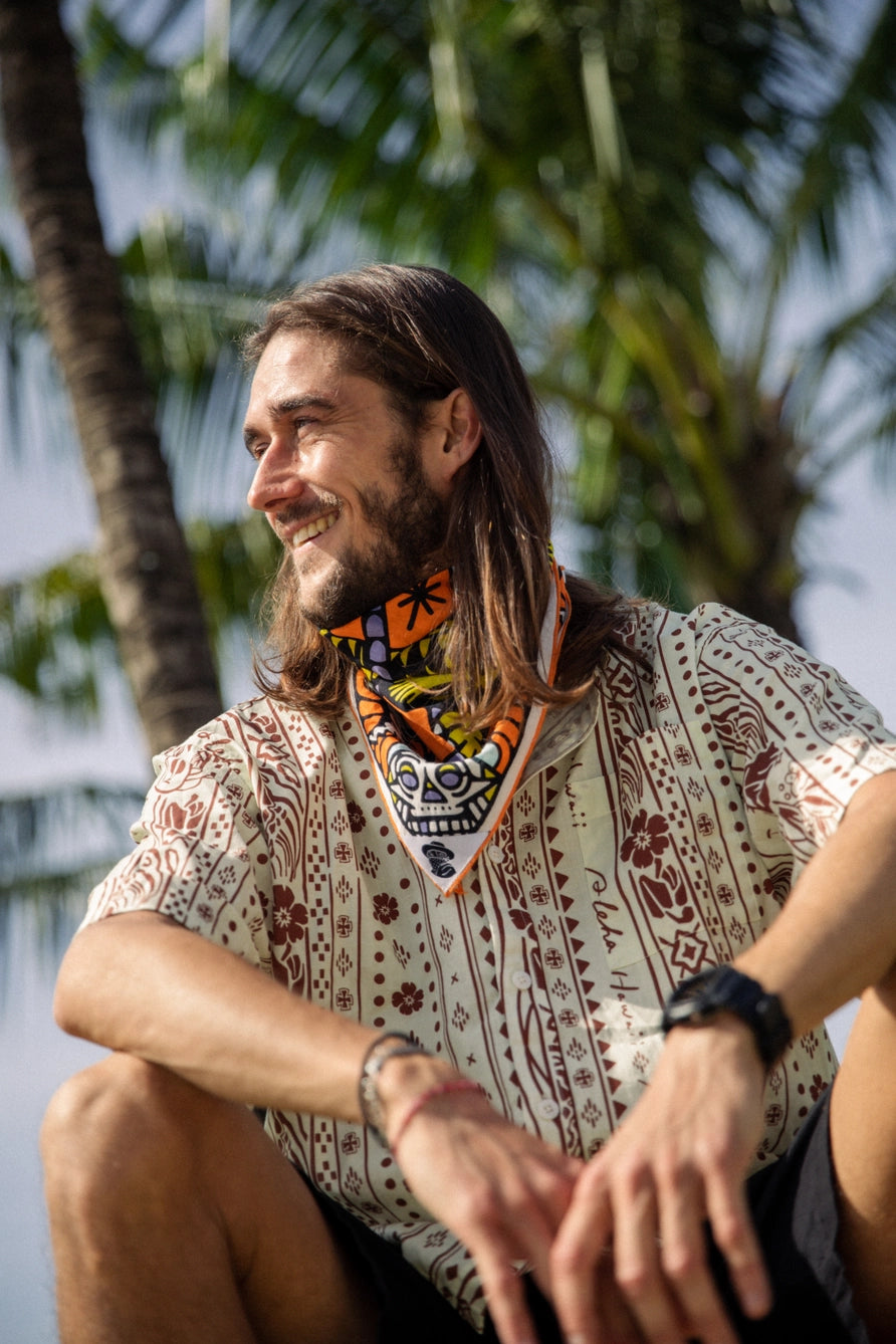 Bandits Bandana Trapped In bandana being worn by a man in front of a palm tree.