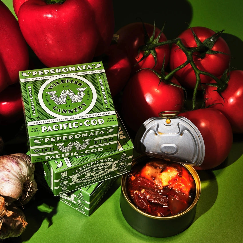 Wildfish Cannery Pacific Cod Peperonata and fresh tomatoes on a green background