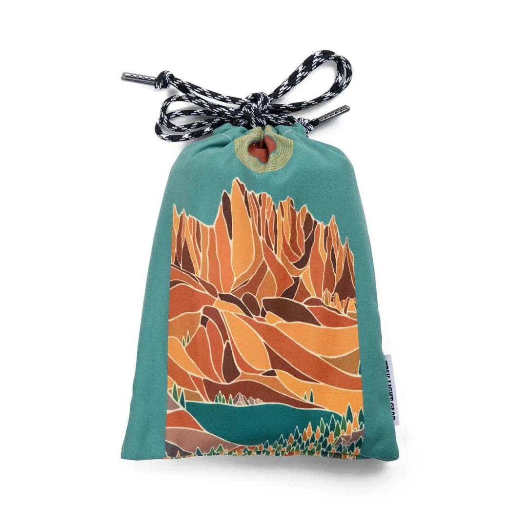 Trek Light Alpenglow Wander towel is made from recycled plastic bottles and includes a bag for carrying.