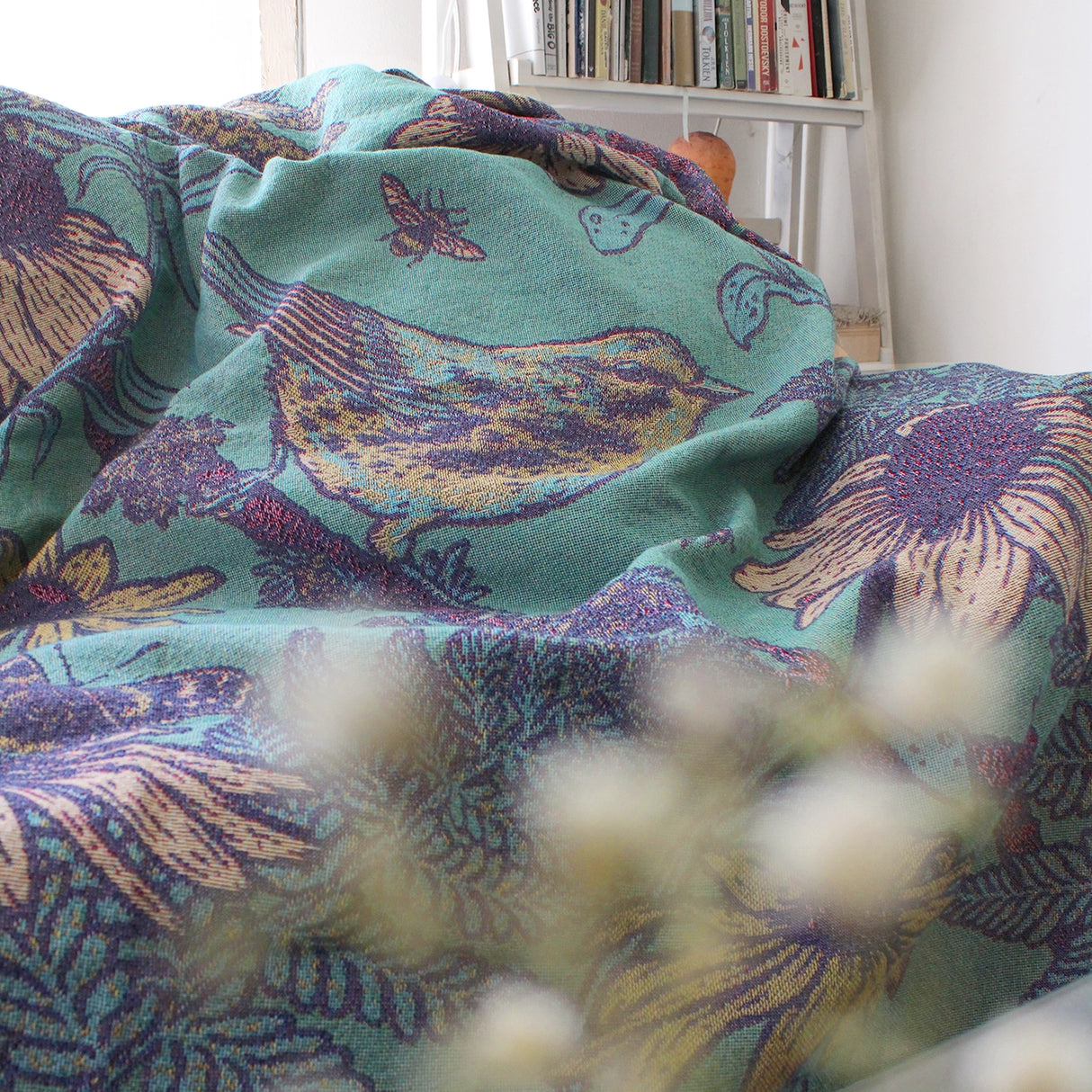 Mustard Beetle Prairie Woven Blanket Tapestry on a couch at home.
