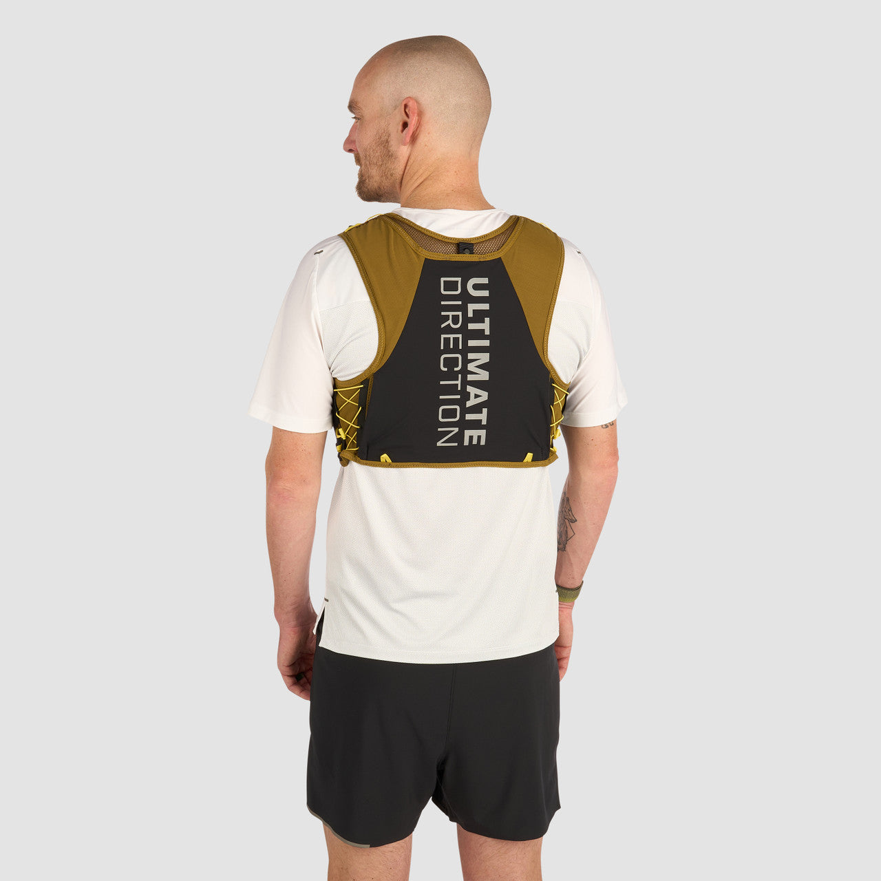Ultimate Direction Xodus Vest in Fig Green being worn from the rear on a neutral background.