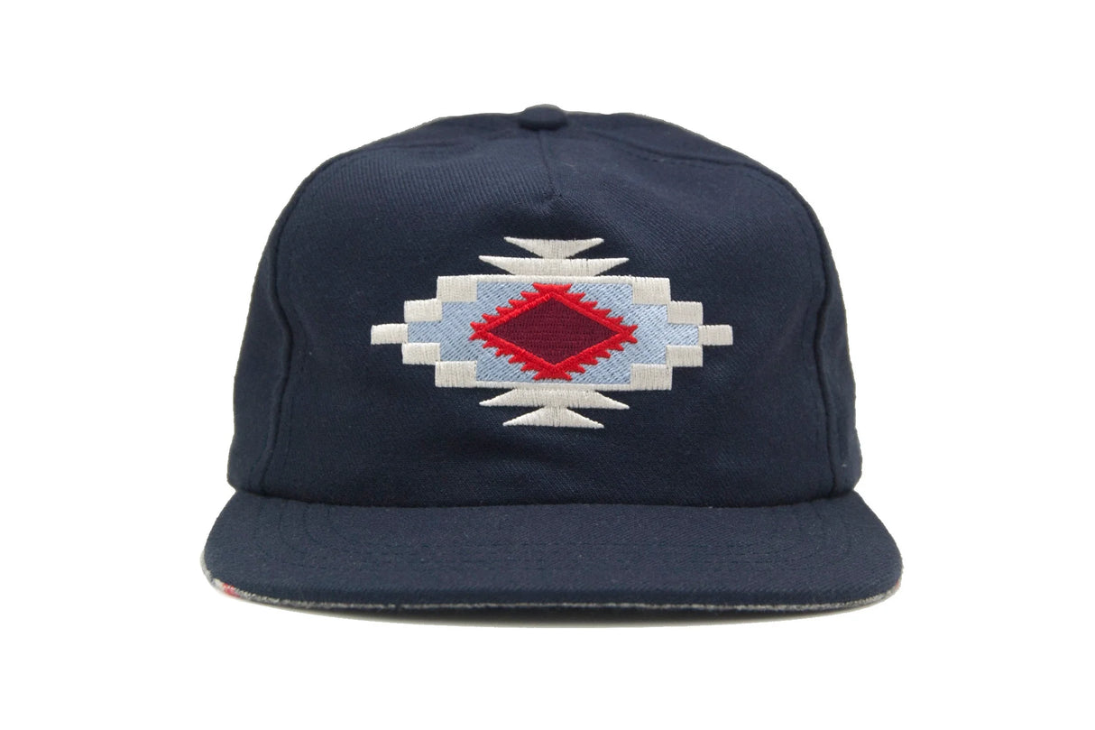 Navy blue Ampal Creative Chimayo Strapback Hat with a geometric pattern on a white background