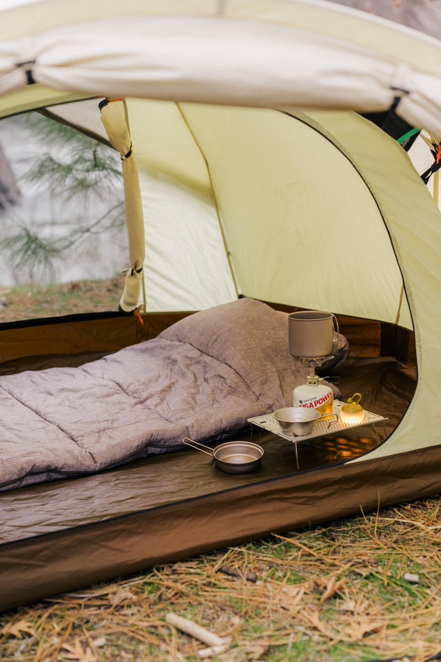 Snow Peak LiteMax Titanium Stove on a camping background.