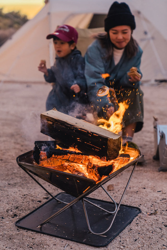Takibi Fire & Grill Set camping fireplace being used outdoors.