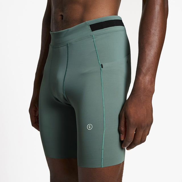 Ciele Athletics M FSTTight Short 8" men's running half tight in Silver Pine worn by a runner on a neutral background.