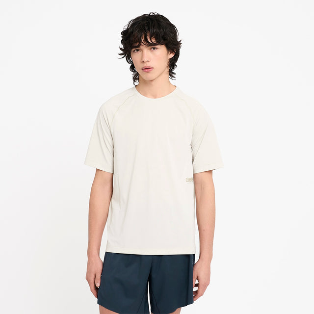Person wearing a Ciele Athletics men's DLYTshirt Running Shirt in Rainy Day and dark shorts on a white background