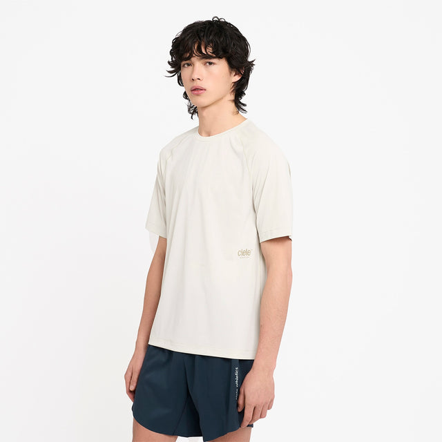Person wearing a Ciele Athletics men's DLYTshirt Running Shirt in Rainy Day and navy shorts on a white background