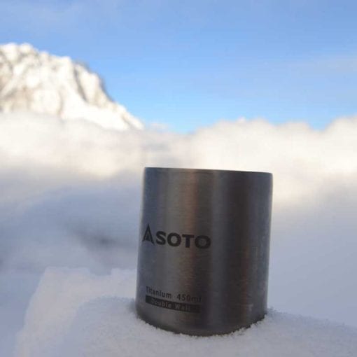 SOTO Aero Mug 450 ml titanium camp mug on a snowy background.