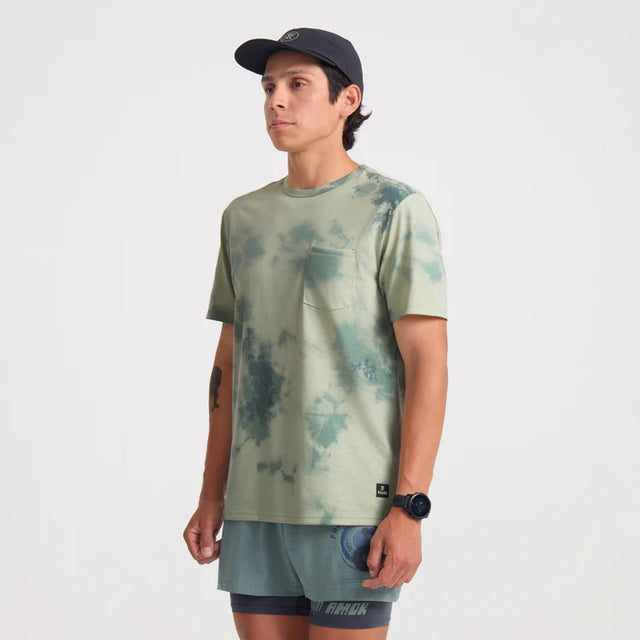 Man wearing a Roark Mathis Active Tie Dye Pocket Short Sleeve Tee in Seafoam and cap on a white background