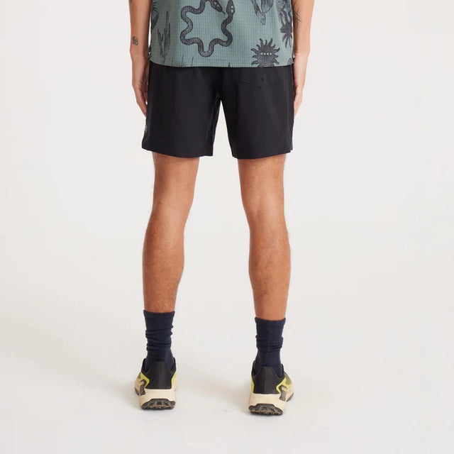 Person wearing Roark Serrano 7" Active Stretch Shorts in Black on a white background
