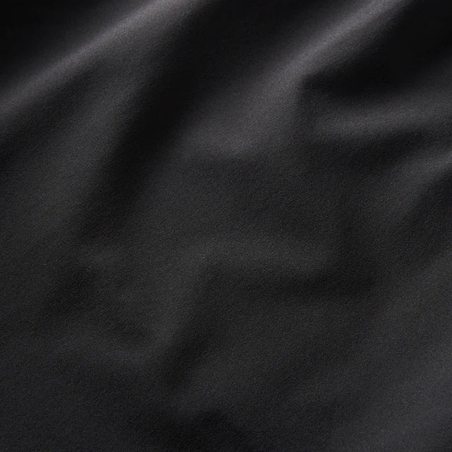 Close-up of Roark Serrano 7" Active Stretch Shorts in Black fabric texture