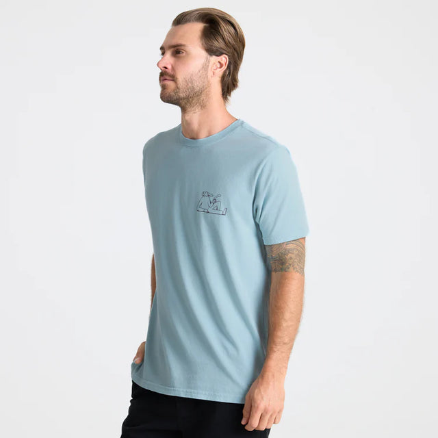 Man wearing a Light blue Roark Unhustle Premium Tee with a small logo on a white background