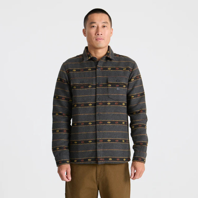 Man wearing a Roark Men's Nordsman Long Sleeve Flannel in Onyx on a plain background