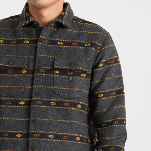 Roark Men's Nordsman Long Sleeve Flannel in Onyx with patterned collar and chest pocket on a light gray background