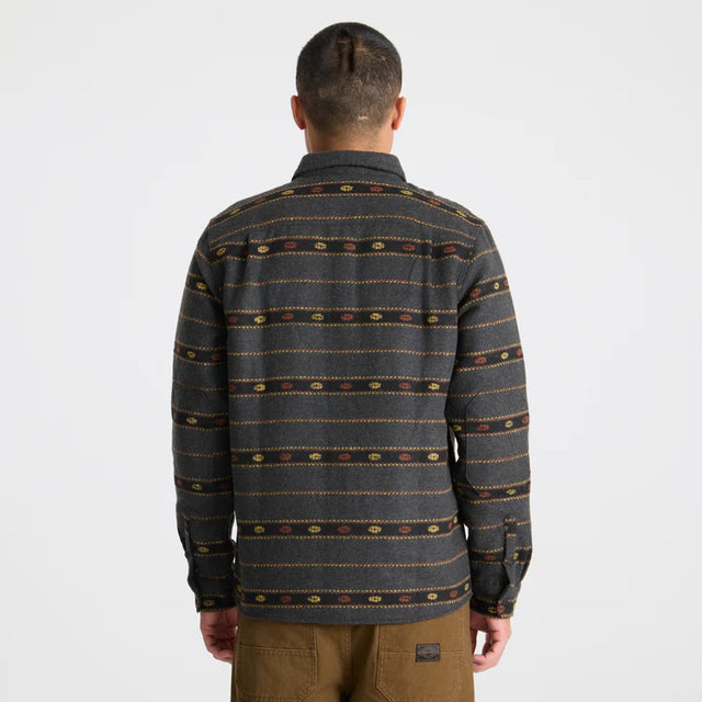 Person wearing a Roark Men's Nordsman Long Sleeve Flannel in Onyx with a plain background