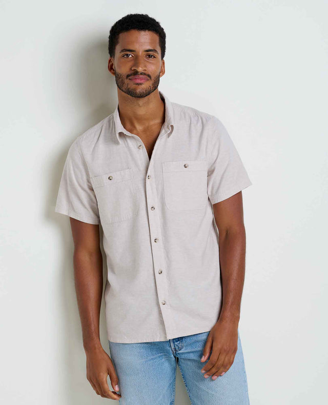 Toad&Co Men's Taj Hemp Short Sleeve Shirt in Oatmeal worn by a man.