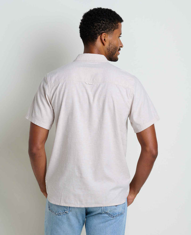 Toad&Co Men's Taj Hemp Short Sleeve Shirt in Oatmeal worn by a man.