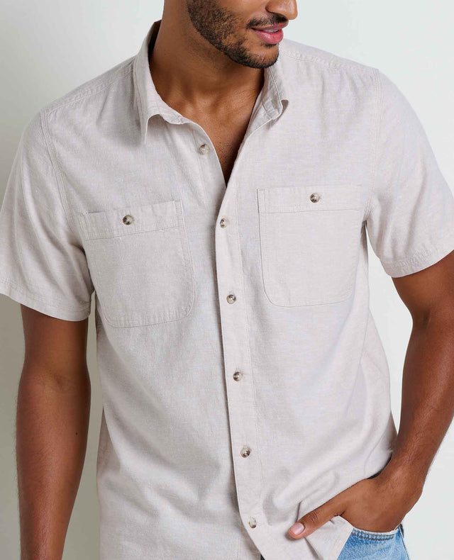 Toad&Co Men's Taj Hemp Short Sleeve Shirt in Oatmeal worn by a man.