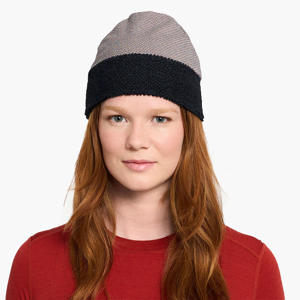 Person wearing a ciele UHBeanie fleece running beanie in Peachskin on a white background