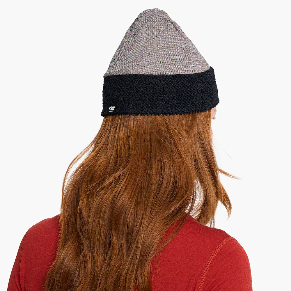 Person wearing a ciele UHBeanie fleece running beanie in Peachskin with a visible brand logo on a white background