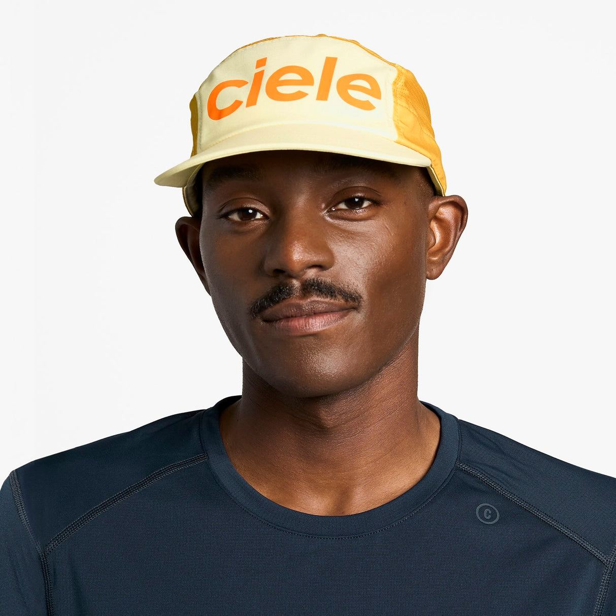 Ciele Athletics GOCap Comp Century running hat in Glade worn by a man on a neutral background.