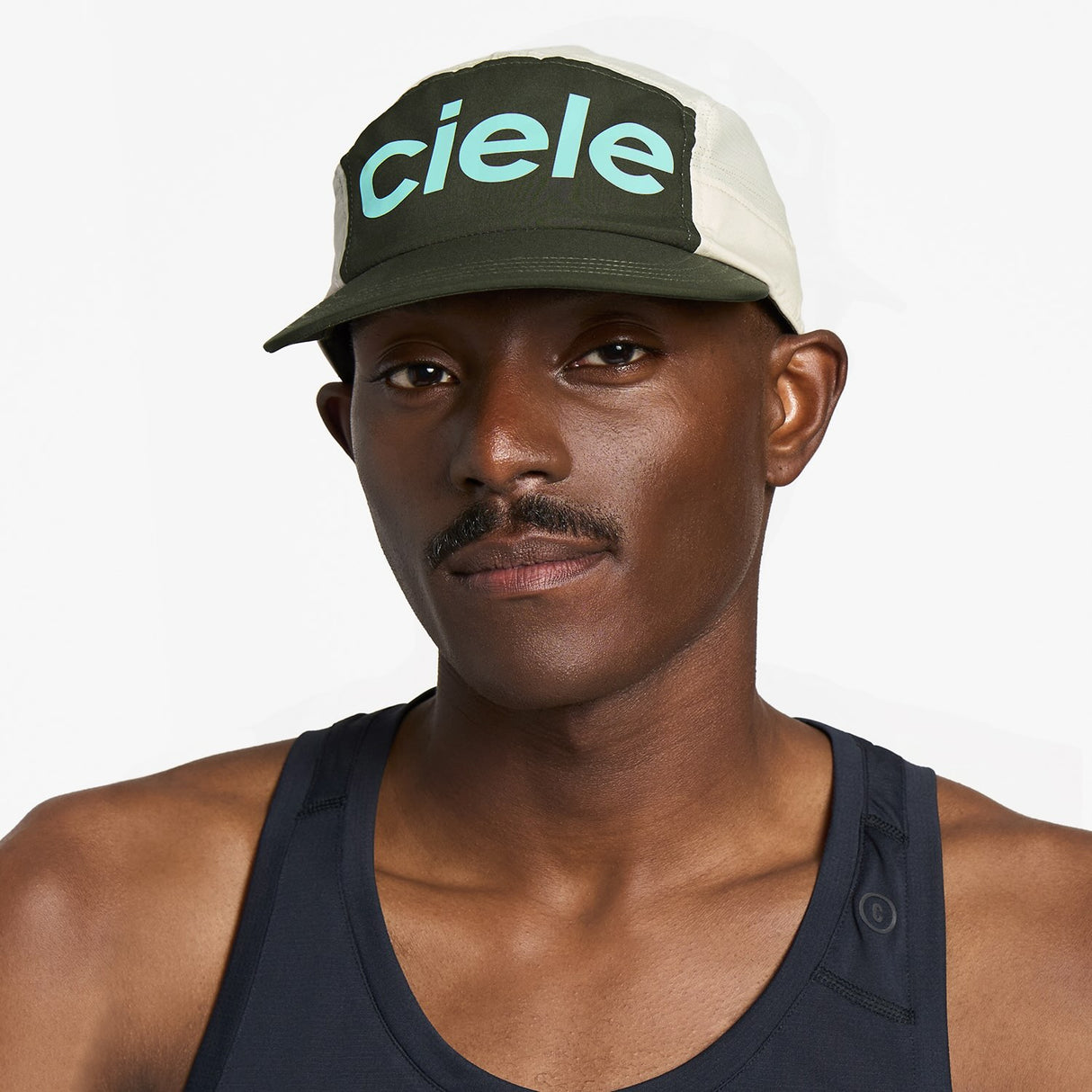 Ciele Athletics GOCap Comp Century running hat in Seaweed/Rainy Day worn by a man on a neutral background.