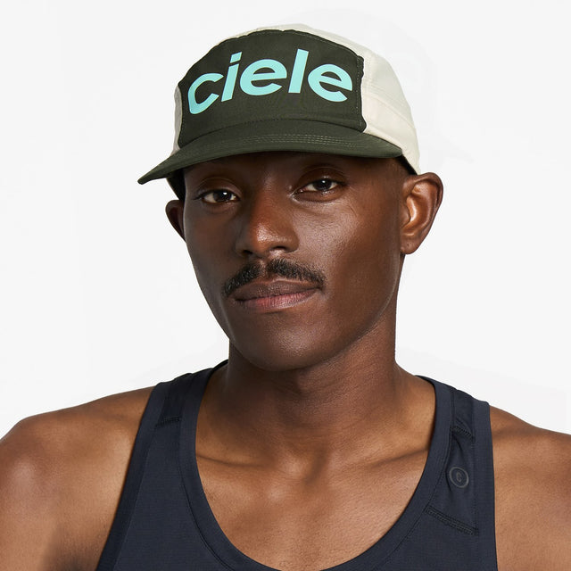 Ciele Athletics GOCap Comp Century running hat in Seaweed/Rainy Day worn by a man on a neutral background.
