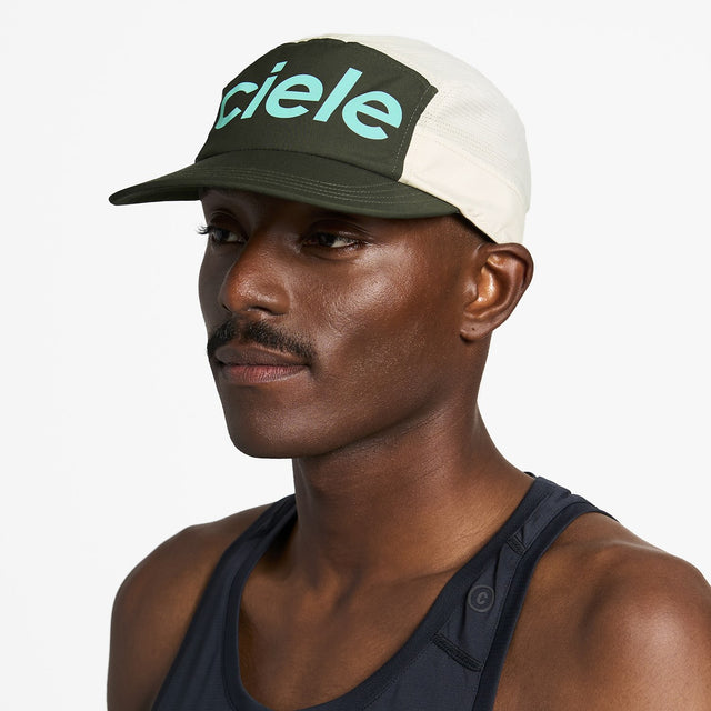 Ciele Athletics GOCap Comp Century running hat in Seaweed/Rainy Day worn by a man on a neutral background.