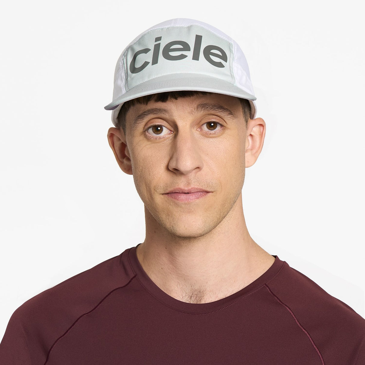 Ciele Athletics GOCap Comp Century running hat in Light Grey/White worn by a man on a neutral background.