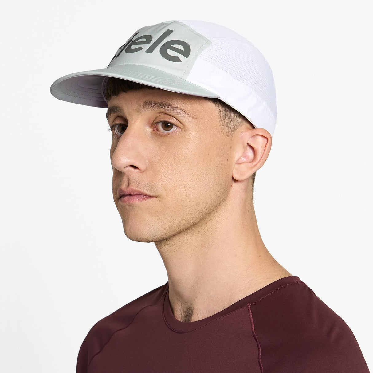 Ciele Athletics GOCap Comp Century running hat in Light Grey/White worn by a man on a neutral background.