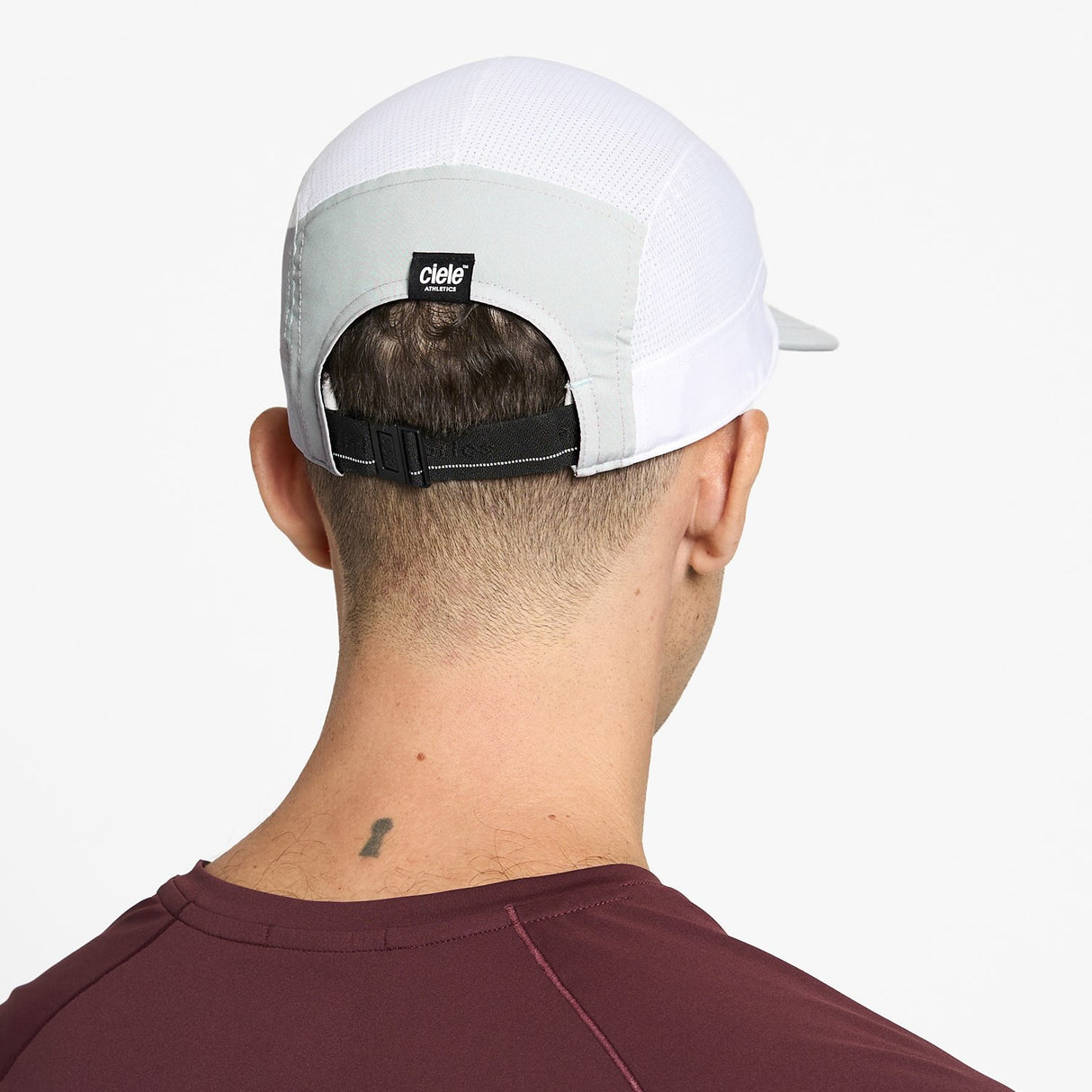 Ciele Athletics GOCap Comp Century running hat in Light Grey/White worn by a man on a neutral background.