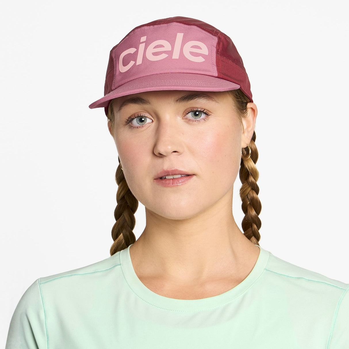 Ciele Athletics GOCap Comp Century running hat in Deco Rose/Merlot worn by a woman on a neutral background.
