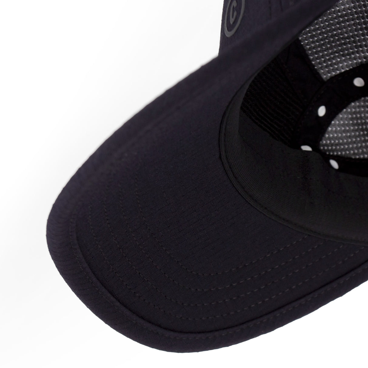 Close-up of a Ciele Athletics GOCap SC Field - Clow Shadowcast Black running cap with a white logo on a white background