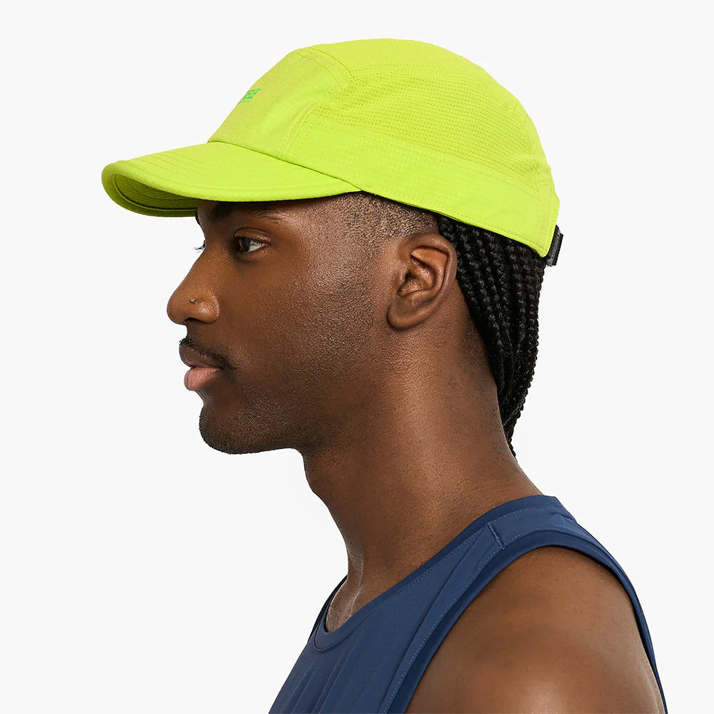 Man wearing a ciele athletics GOCap SC Field - Capital RC running hat in Lime Green on a white background