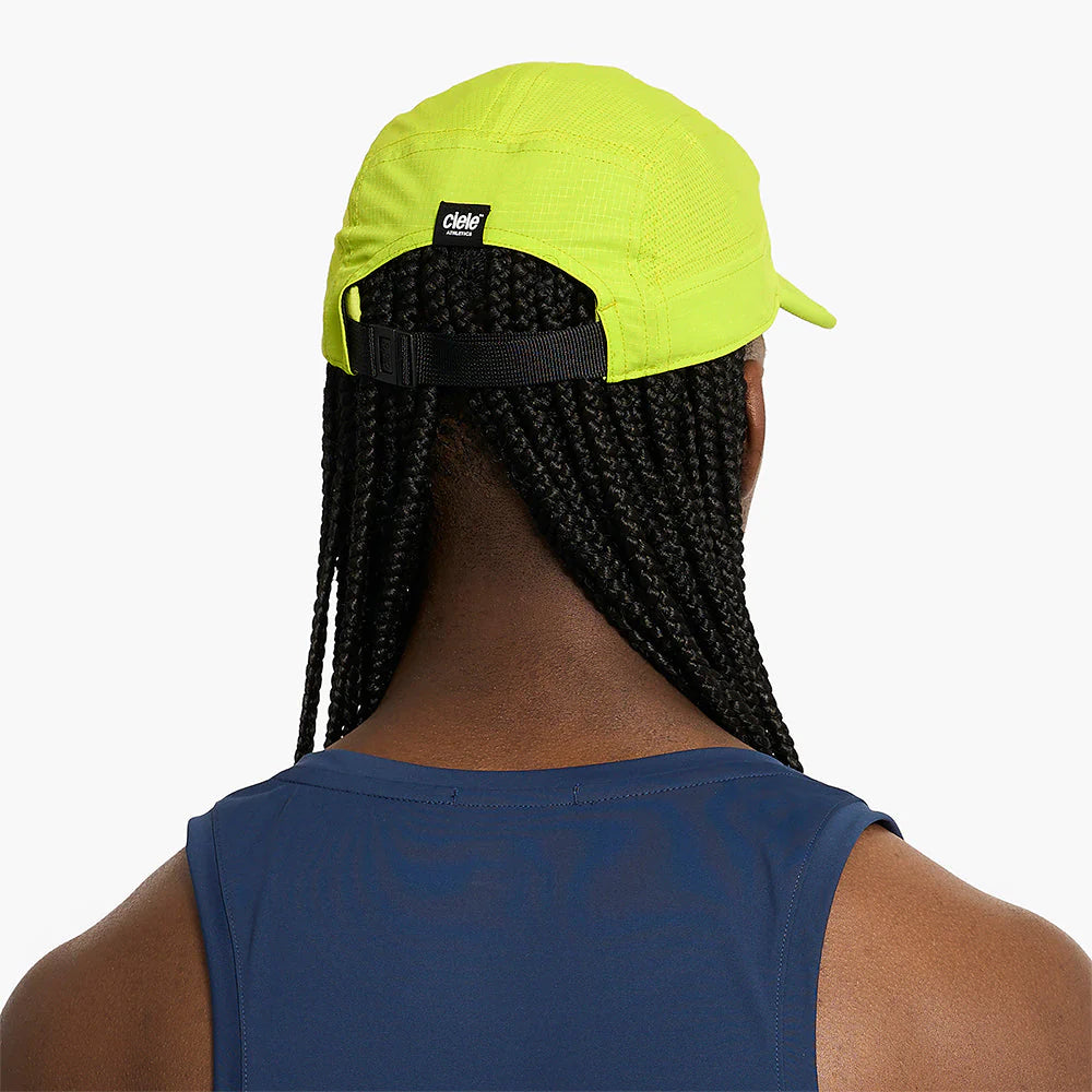 Person wearing a ciele athletics GOCap SC Field - Capital RC running hat in Lime Green with a brand logo on a white background