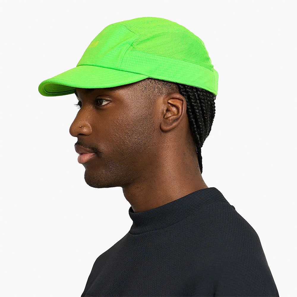 Person wearing a ciele athletics GOCap SC Field - Capital RC running hat in Acid Green on a white background