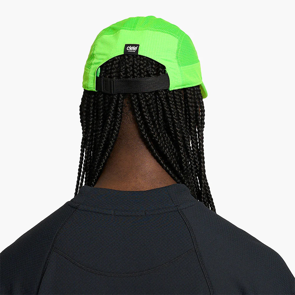 Person wearing a ciele athletics GOCap SC Field - Capital RC running hat in Acid Green with a brand logo on a plain background