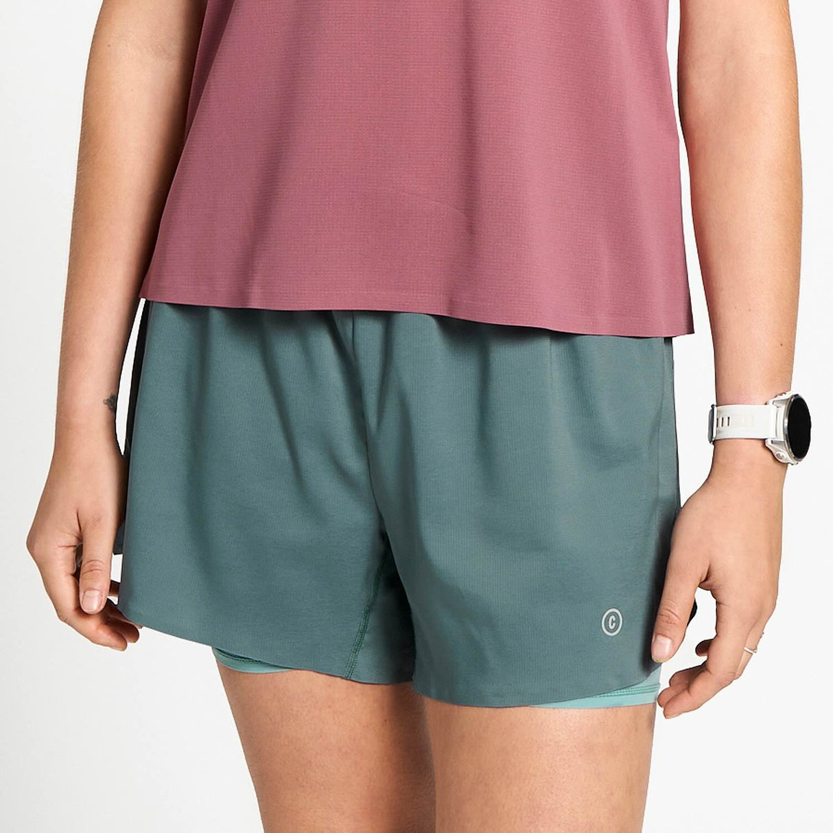 Ciele Athletics W DLYShort 4" Long Brief women's running shorts in Silver Pine worn by a woman on a neutral background.
