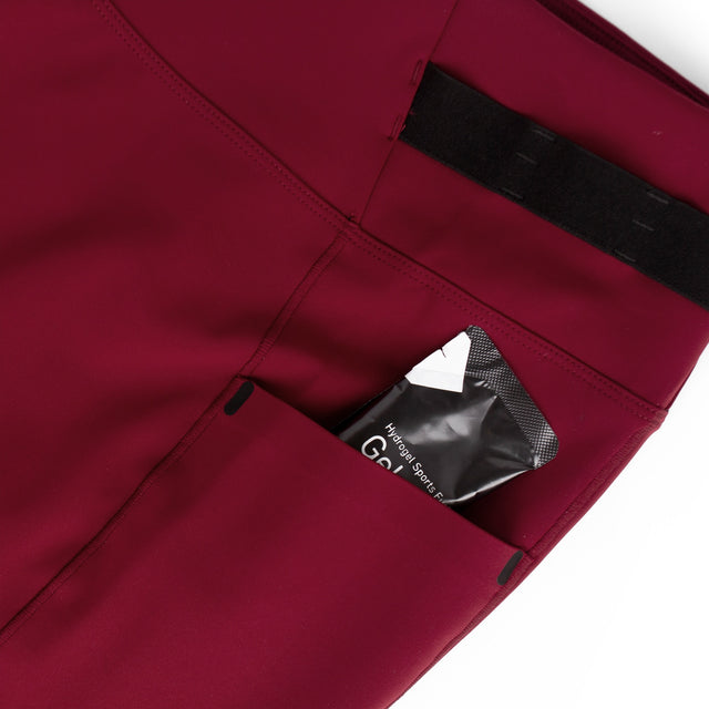 Ciele Athletics Women's FSTTight Short 7" in Crimson Red side pocket on a white background